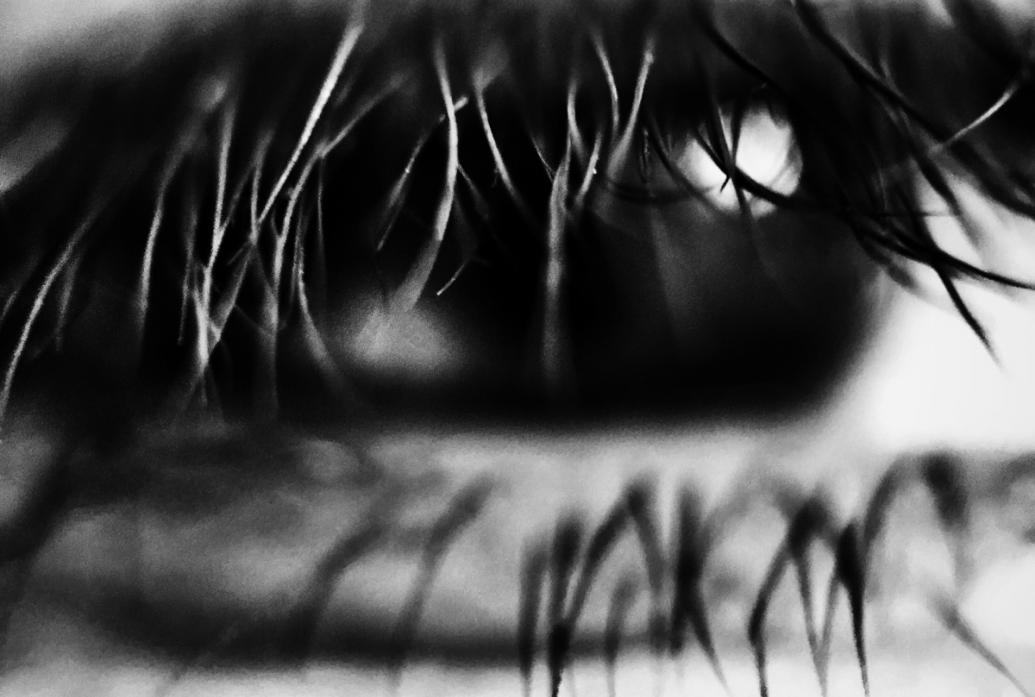 A black and white close up photo of an eye